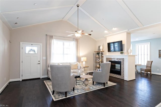 living room featuring a brick fireplace, dark wood-type flooring, high vaulted ceiling, and ceiling fan