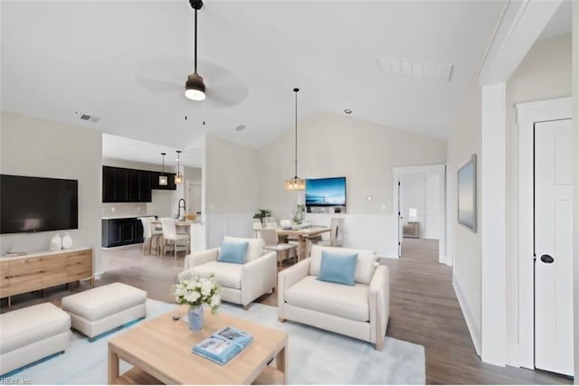 living room featuring high vaulted ceiling, ceiling fan, hardwood / wood-style flooring, and sink