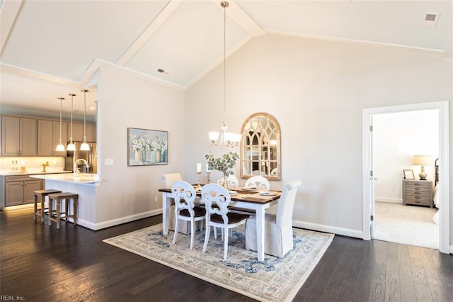 dining room with dark hardwood / wood-style flooring, a chandelier, and high vaulted ceiling