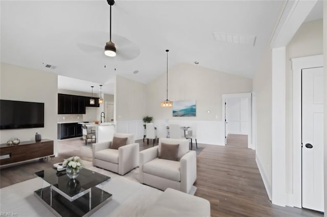 living room with lofted ceiling, dark wood-type flooring, ceiling fan, and sink