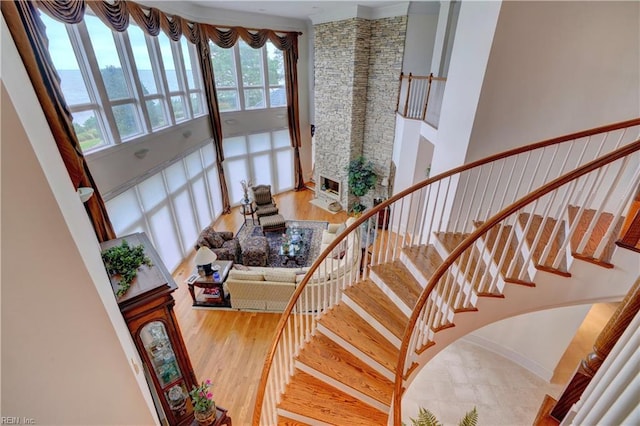 stairs with a high ceiling and hardwood / wood-style floors