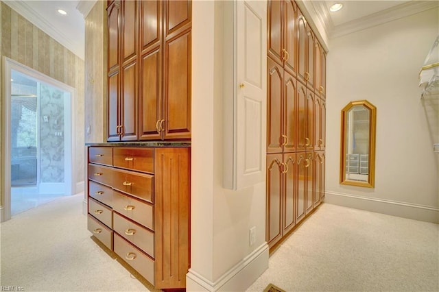 hall with light colored carpet and crown molding