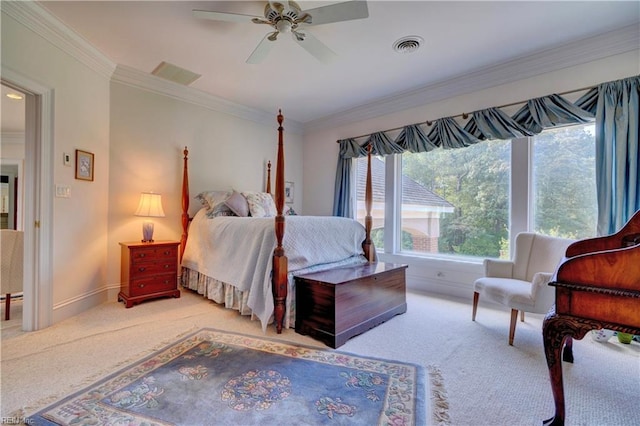 carpeted bedroom featuring ceiling fan and crown molding