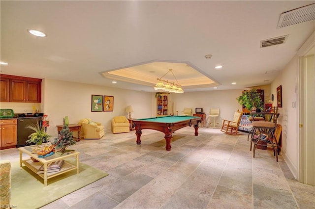 playroom featuring billiards, a tray ceiling, and indoor bar