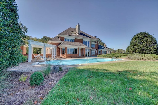 back of property featuring a yard, a pergola, and a patio area