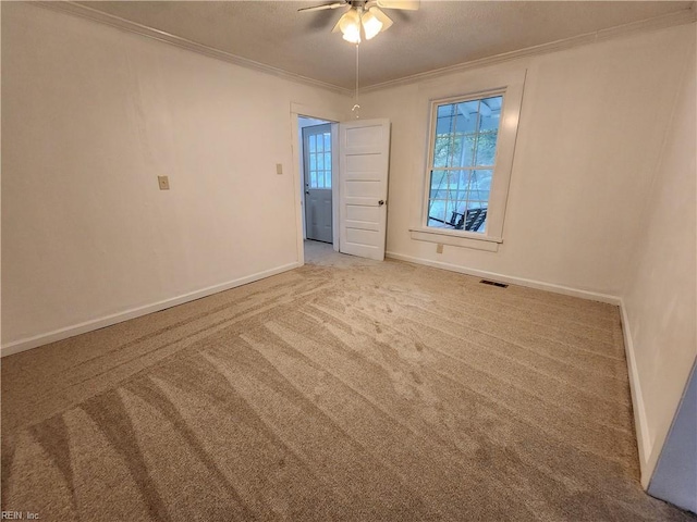 carpeted empty room featuring ceiling fan and ornamental molding