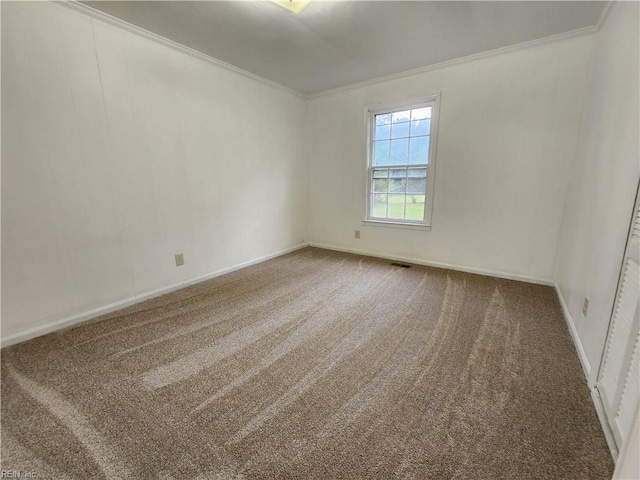 empty room with ornamental molding and carpet floors