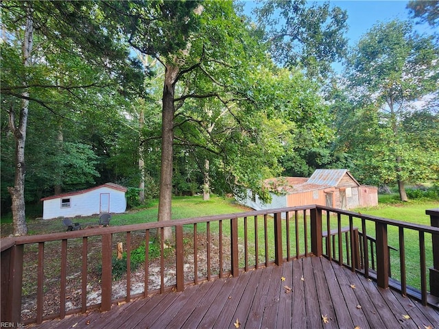 deck featuring a storage unit and a yard