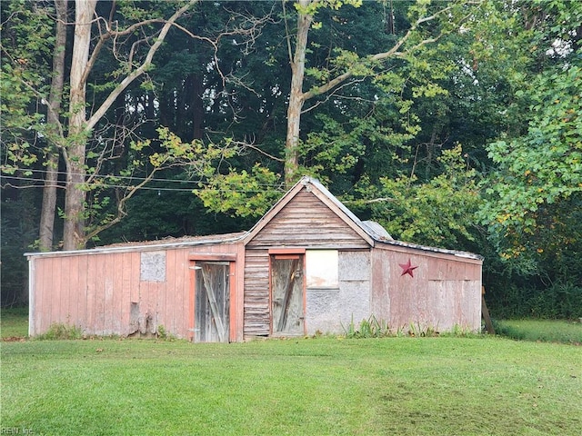 view of outbuilding with a yard