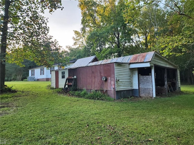 view of outbuilding with a lawn and central AC