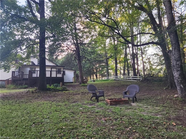 view of yard featuring a fire pit and a deck