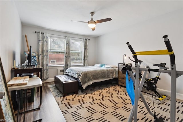 bedroom with ceiling fan, radiator, and light hardwood / wood-style flooring