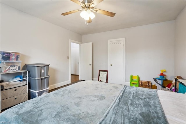 bedroom with ceiling fan and dark wood-type flooring