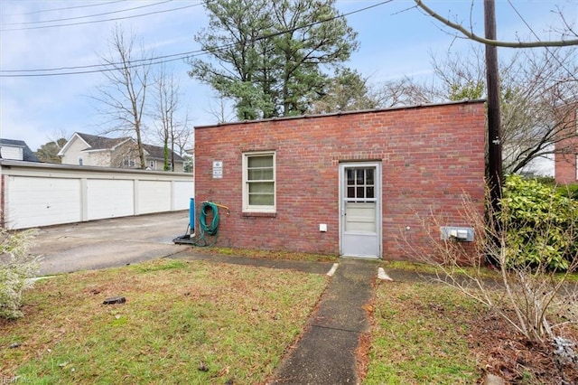 exterior space featuring a lawn and a garage