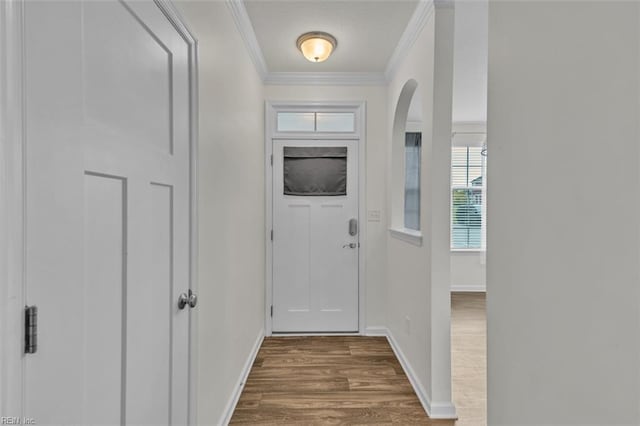 doorway with hardwood / wood-style flooring and ornamental molding