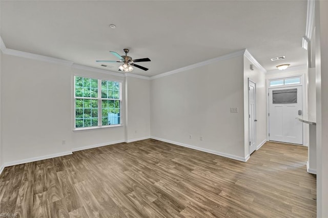 spare room featuring light hardwood / wood-style floors, ceiling fan, and crown molding