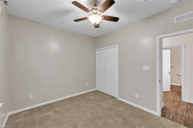 unfurnished bedroom featuring light carpet, a closet, and ceiling fan