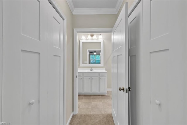 hall featuring crown molding, sink, and light carpet