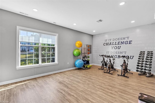 exercise room with wood-type flooring