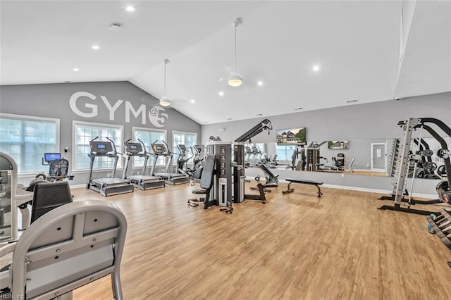 workout area with ceiling fan, hardwood / wood-style flooring, and high vaulted ceiling