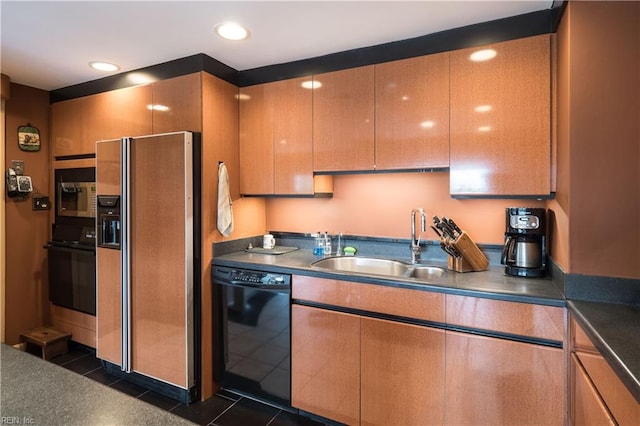 kitchen featuring dark tile patterned floors, black appliances, and sink