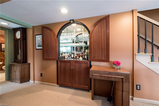 bar featuring light colored carpet and wood counters