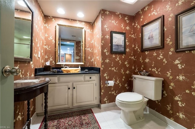 bathroom with vanity, toilet, and tile patterned flooring