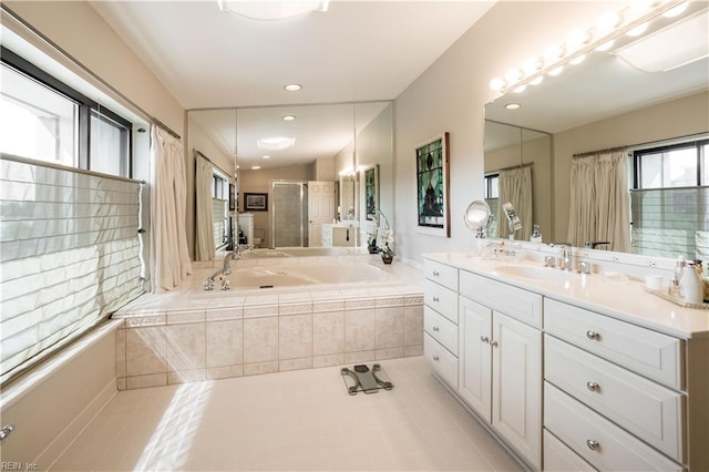 bathroom with shower with separate bathtub, tile patterned flooring, and vanity