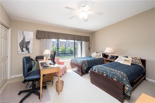 bedroom with ceiling fan, a closet, and light carpet