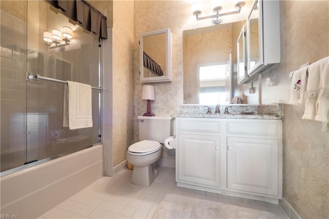 full bathroom with vanity, tile patterned floors, toilet, and combined bath / shower with glass door