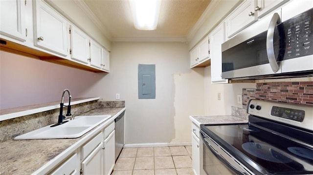 kitchen with crown molding, white cabinetry, and stainless steel appliances