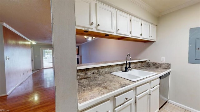 kitchen featuring white cabinetry, electric panel, crown molding, light hardwood / wood-style flooring, and sink