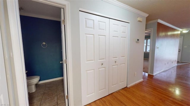 hall featuring crown molding and hardwood / wood-style flooring