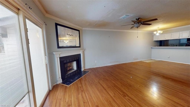 unfurnished living room with a textured ceiling, light hardwood / wood-style floors, ceiling fan, and crown molding