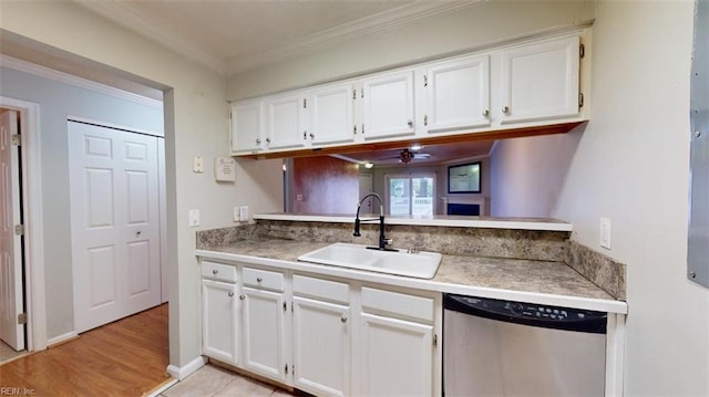 kitchen featuring light hardwood / wood-style floors, white cabinetry, stainless steel dishwasher, ornamental molding, and sink