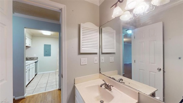 bathroom featuring vanity, electric panel, a notable chandelier, crown molding, and hardwood / wood-style floors