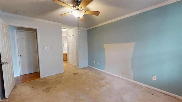 unfurnished bedroom featuring ceiling fan, light colored carpet, a textured ceiling, and ornamental molding