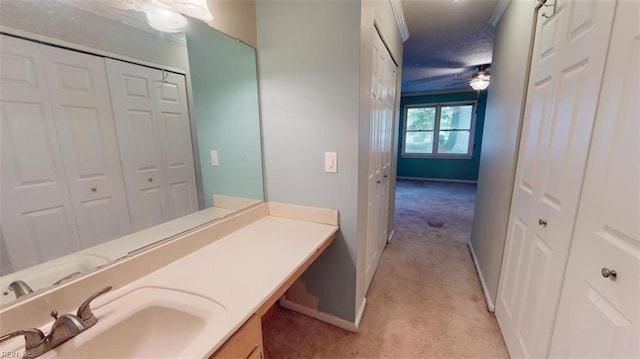 bathroom with ceiling fan and vanity