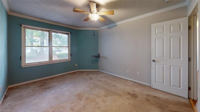 carpeted spare room with ceiling fan, a textured ceiling, and ornamental molding