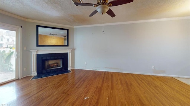 unfurnished living room featuring ceiling fan, ornamental molding, a textured ceiling, and hardwood / wood-style floors