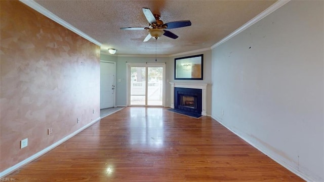 unfurnished living room with wood-type flooring, ceiling fan, a textured ceiling, and crown molding