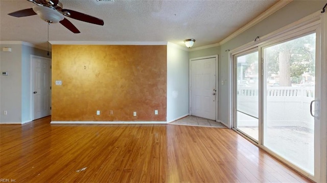 unfurnished room featuring ornamental molding, wood-type flooring, ceiling fan, and a textured ceiling