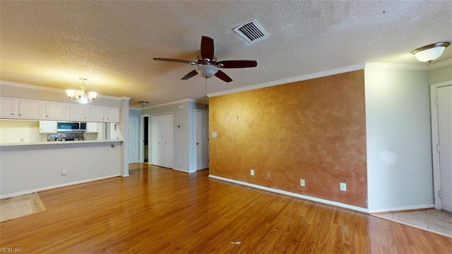 unfurnished living room featuring a textured ceiling, ceiling fan with notable chandelier, crown molding, and hardwood / wood-style flooring