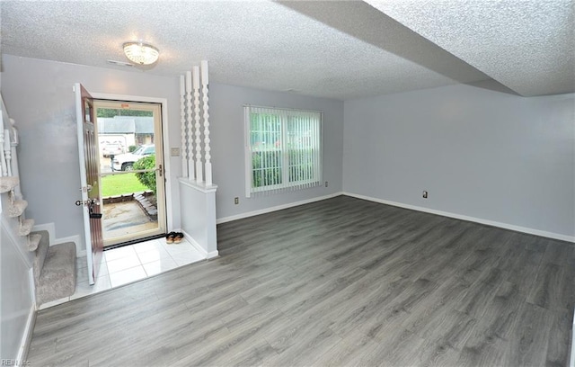 foyer entrance featuring a textured ceiling and hardwood / wood-style flooring