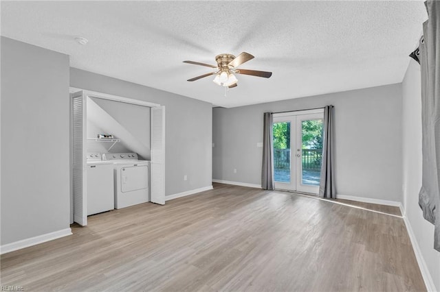 unfurnished living room with light hardwood / wood-style flooring, ceiling fan, separate washer and dryer, and a textured ceiling