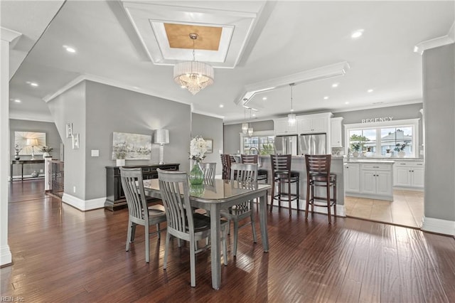 dining room featuring an inviting chandelier, crown molding, and hardwood / wood-style floors