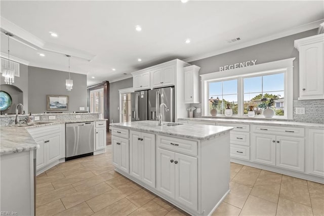 kitchen with sink, white cabinetry, a center island with sink, appliances with stainless steel finishes, and decorative light fixtures