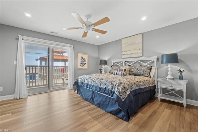 bedroom featuring hardwood / wood-style floors, ceiling fan, and access to exterior