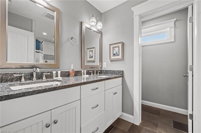 2816 Sandfiddler Rd, Virginia Beach, VA 23456 - bathroom with double vanity, baseboards, and curtained shower