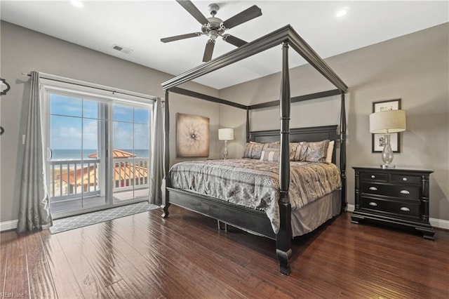 bedroom with ceiling fan, a water view, dark hardwood / wood-style floors, and access to outside